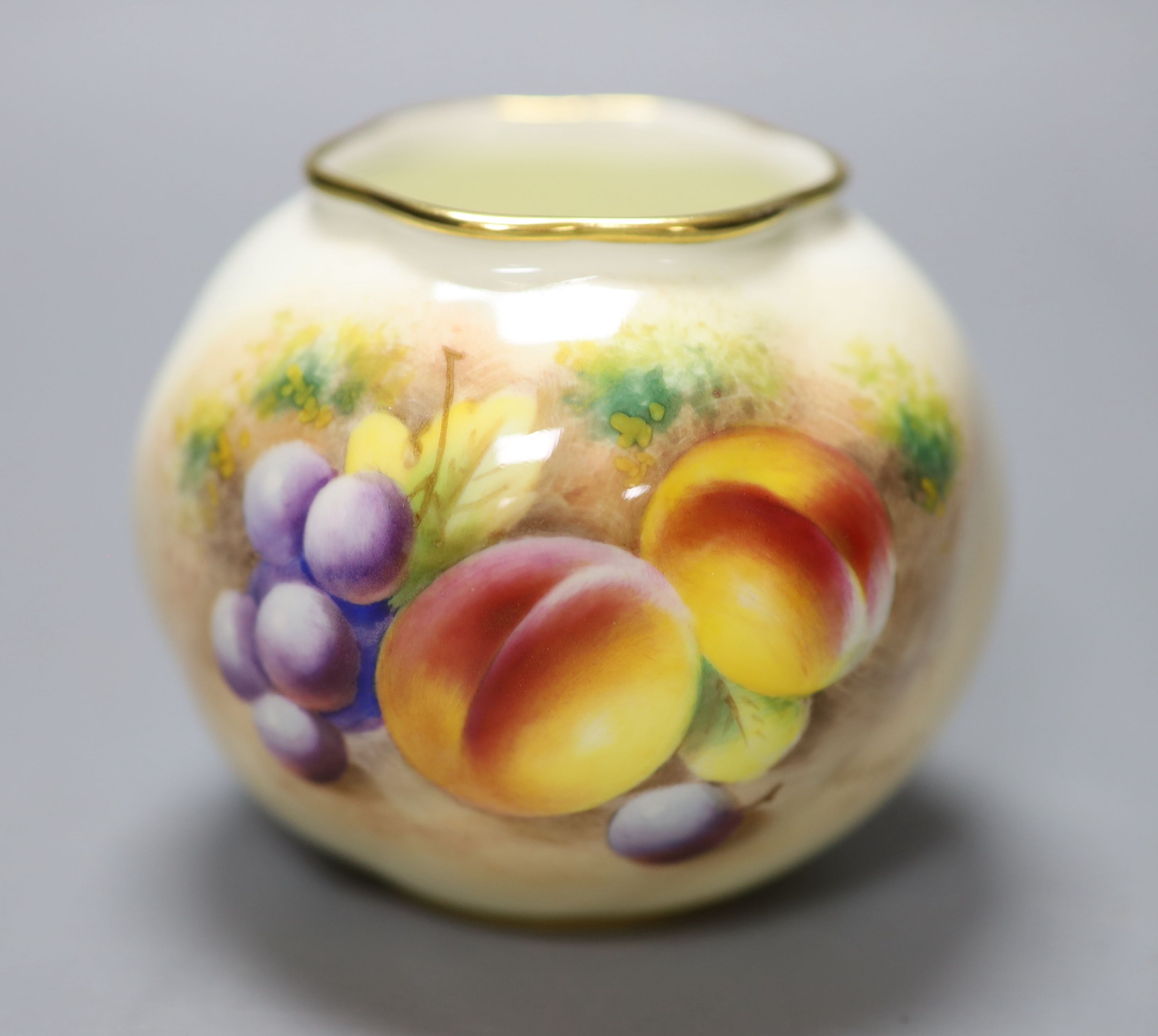 A Royal Worcester spirally moulded globular vase painted with fruits by Roberts, date code for 1955, height 7cm